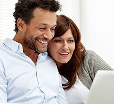 A couple enjoying convenient online scheduling from the comfort of their home. 